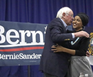 Democratic presidential candidate Sen. Bernie Sanders, D-Vt., and Rep. Ilhan Omar, D-Minn., hug after she introduced him at a campaign event, Dec. 13, 2019, in Manchester, N.H.