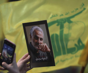 A Hezbollah flag and photo of the slain Iranian Revolutionary Guard General Qassem Soleimani