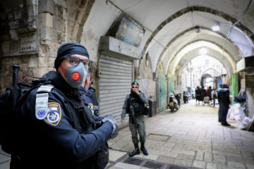Israeli border police wear face masks