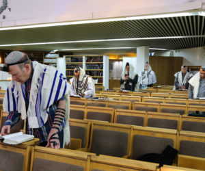 Jewish men attend morning prayer