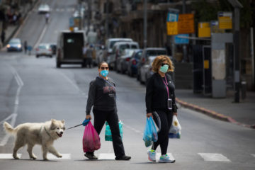 People walk with their shopping bags