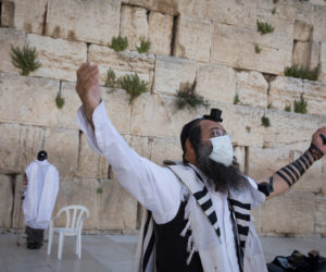 Jewish men pray at the Western Wall