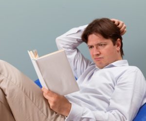 Man reading confused