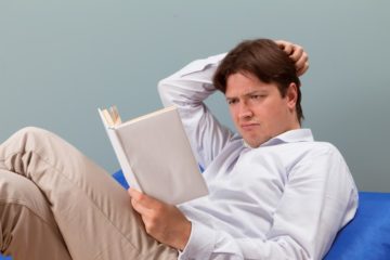 Man reading confused