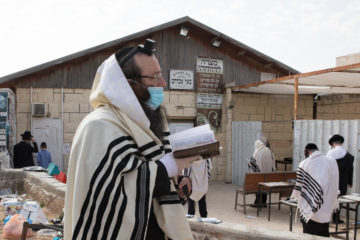 Jewish men pray outside