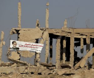 bashar assad poster on destroyed syrian building