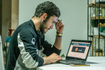 A young man viewing a website at his home in Moshav Yashresh, on May 6, 2020. (Flash90/Yossi Aloni)