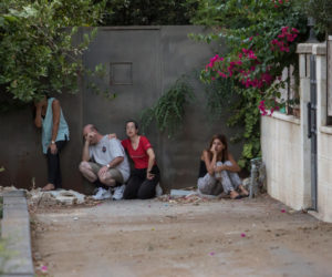 Israelis take cover during a rocket attack