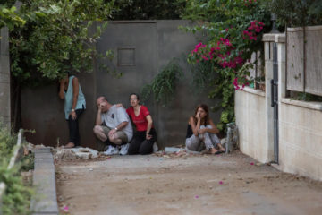 Israelis take cover during a rocket attack