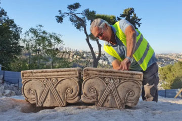 Director of the Jerusalem Promenade excavation Yaakov Billig with the unearthed capitals.