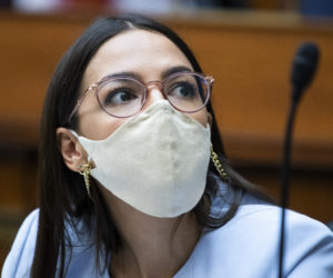 Rep. Alexandria Ocasio-Cortez, D-N.Y., listens during a House Oversight and Reform Committee hearing on Monday, Aug. 24, 2020, in Washington. (AP Photo/Pool/Tom Williams)