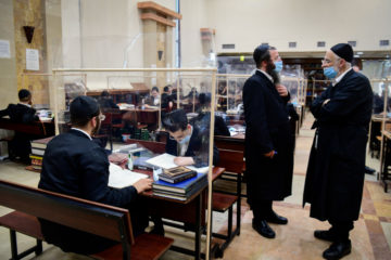 ultra-orthodox men studying Torah in a yeshiva