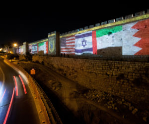 U.S., United Arab Emirates, Israel and Bahrain flags on the walls of Jerusalem's Old City