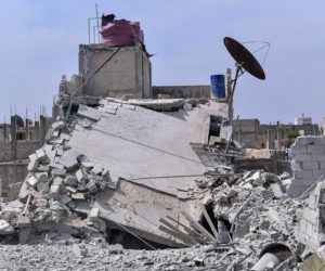 This photo released by the Syrian official news agency SANA, shows the rubble of a house that according to the Syrian authorities was attacked by an Israeli airstrike, in the Damascus suburbs of Hajira, Syria, Monday, April 27, 2020. (AP Photo/SANA)