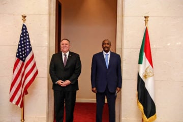 U.S. Secretary of State Mike Pompeo stands with Sudanese Gen. Abdel-Fattah Burhan, the head of the ruling sovereign council, in Khartoum, Sudan, Tuesday, Aug. 25, 2020. (AP Photo/Sudanese Cabinet)