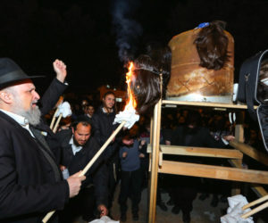 Haredi men burn non-kosher wigs in the city of Beit Shemesh, on January 30, 2019. (Flash90/ Yaakov Lederman)