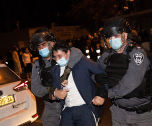 Israel Police officers arrest a protester during a protest against the enforcement of coronavirus emergency regulations, outside the Haredi neighborhood of Mea Shearim, Jerusalem, October 5, 2020. (Flash90/Yonatan Sindel)