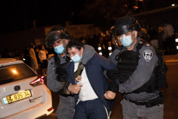 Israel Police officers arrest a protester during a protest against the enforcement of coronavirus emergency regulations, outside the Haredi neighborhood of Mea Shearim, Jerusalem, October 5, 2020. (Flash90/Yonatan Sindel)
