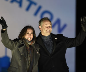 Democratic vice presidential candidate Sen. Kamala Harris, D-Calif., and her husband Doug Emhoff take the stage during a drive-in get out the vote rally, Monday, Nov. 2, 2020, in Philadelphia. (AP Photo/Michael Perez)