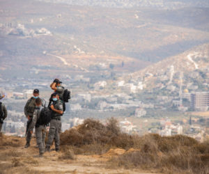 Israeli border police officers stand guard near the Yitzhar setllment where illegal structures where demolished earlier in the morning in April 2020. (Flash90/Sraya Diamant)