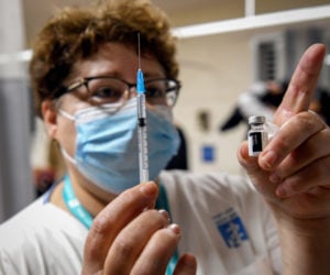 A nurse with a Covid-19 vaccine, at the Shamir Medical Center in Be'er Ya'akov, on December 30, 2020. (Flash90/Avi Dishi)