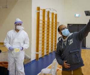 An Israeli man takes a selfie at a coronavirus testing center in Jerusalem on January 19, 2021. (Flash90/Olivier Fitoussi)