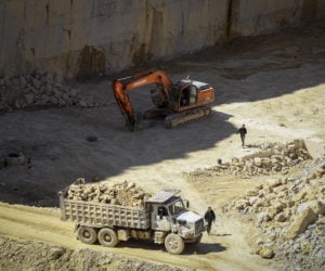 Palestinian workers work at a quarry