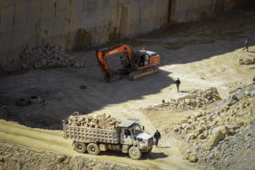 Palestinian workers work at a quarry