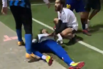 An Israeli aids a teammate who was knocked unconscious by an illegal migrant during a confrontation on a south Tel Aviv soccer field. (Twitter/Doron Avrahami/Screenshot)