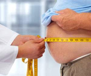 Doctor Measuring Obese Man
