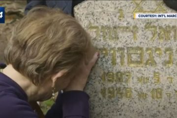 Holocaust survivor at grave of her father