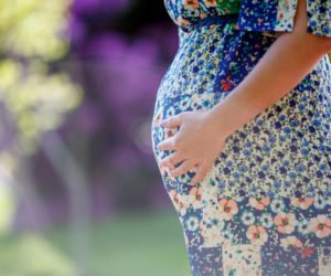 Surrogate,Pregnant,Woman,With,Big,Belly,In,A,Floral,Dress
