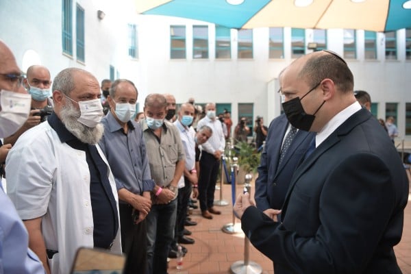 Prime Minister Bennett removes Israeli flag pin during visit to Arab town