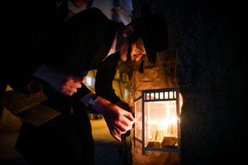 Ultra-Orthodox man lights Hannukah candles
