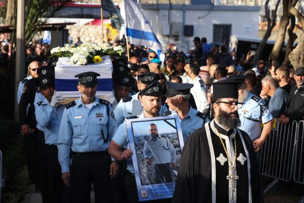 ‘Hero’ police officer laid to rest as thousands pay respects