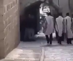 Jews in prayer shawls on way to Western Wall.v1