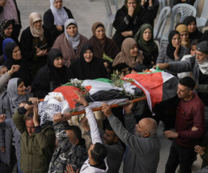 Palestinians carry the body of Jana Zakaran, 16, during her funeral in the city of Jenin, Monday, Dec. 12, 2022. (AP Photo/Majdi Mohammed)