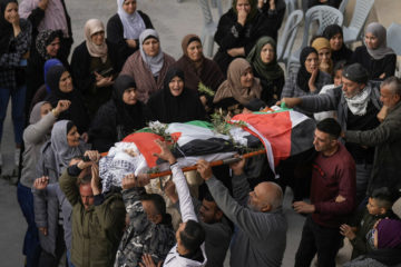 Palestinians carry the body of Jana Zakaran, 16, during her funeral in the city of Jenin, Monday, Dec. 12, 2022. (AP Photo/Majdi Mohammed)