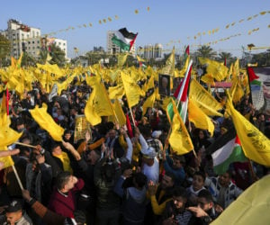 Palestinian Fatah supporters chant slogans and wave the movement's flags during a rally marking the 58th anniversary of Fatah movement foundation in Gaza City, Saturday, Dec. 31, 2022. (AP Photo/Adel Hana)