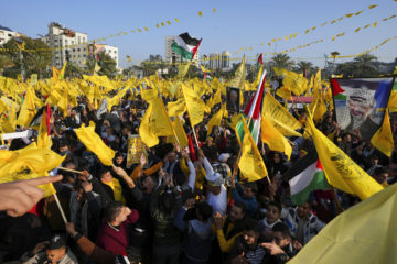 Palestinian Fatah supporters chant slogans and wave the movement's flags during a rally marking the 58th anniversary of Fatah movement foundation in Gaza City, Saturday, Dec. 31, 2022. (AP Photo/Adel Hana)