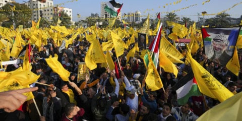 Palestinian Fatah supporters chant slogans and wave the movement's flags during a rally marking the 58th anniversary of Fatah movement foundation in Gaza City, Saturday, Dec. 31, 2022. (AP Photo/Adel Hana)