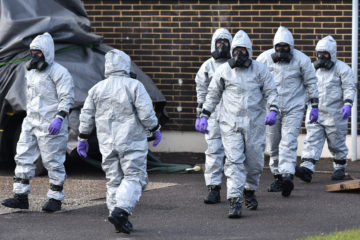 British army and police in hazmat suits