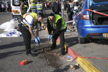Members of Zaka Rescue and Recovery team work at the site of a car-ramming attack that killed three Israelis at a bus stop in Ramot, Jerusalem, Friday, Feb. 10, 2023. (AP Photo/Mahmoud Illean)