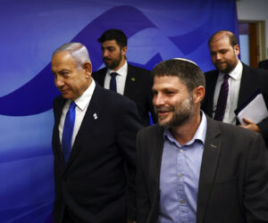 Israeli Prime Minister Benjamin Netanyahu, left, and Finance Minister Bezalel Smotrich, right, arrive to attend a cabinet meeting at the Prime Minister's office in Jerusalem, Thursday, Feb. 23, 2023. (Ronen Zvulun/Pool Photo via AP)