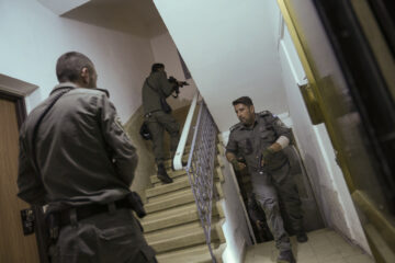 Israeli police officers run upstairs as they search for a Palestinian terrorist in a shooting attack in Tel Aviv, which wounded three people Thursday, March 9, 2023. (AP Photo/Oded Balilty)
