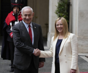 Italian Premier Giorgia Meloni and Israeli Prime Minister Benjamin Netanyahu shake hands for photographers at Chigi Palace government offices in Rome, Friday, March 10, 2023. (AP Photo/Andrew Medichini)