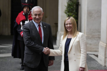 Italian Premier Giorgia Meloni and Israeli Prime Minister Benjamin Netanyahu shake hands for photographers at Chigi Palace government offices in Rome, Friday, March 10, 2023. (AP Photo/Andrew Medichini)