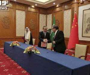 Secretary of Iran's Supreme National Security Council, Ali Shamkhani, right, shakes hands with China's most senior diplomat Wang Yi, as Saudi Arabia's National Security Adviser Musaad bin Mohammed al-Aiban looks on during an agreement signing ceremony between Iran and Saudi Arabia to reestablish diplomatic relations (Nournews via AP)