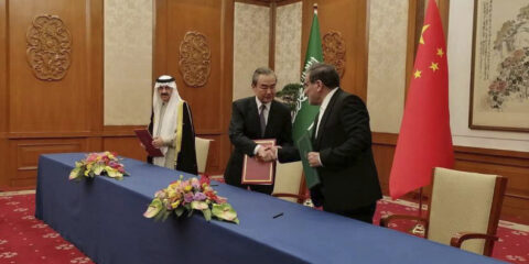 Secretary of Iran's Supreme National Security Council, Ali Shamkhani, right, shakes hands with China's most senior diplomat Wang Yi, as Saudi Arabia's National Security Adviser Musaad bin Mohammed al-Aiban looks on during an agreement signing ceremony between Iran and Saudi Arabia to reestablish diplomatic relations (Nournews via AP)