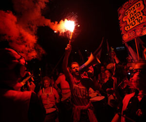 Israelis protest plans by Prime Minister Benjamin Netanyahu's far-right government to overhaul the judicial system, in Tel Aviv, Israel, Saturday, April 1, 2023. (AP Photo/Ohad Zwigenberg)